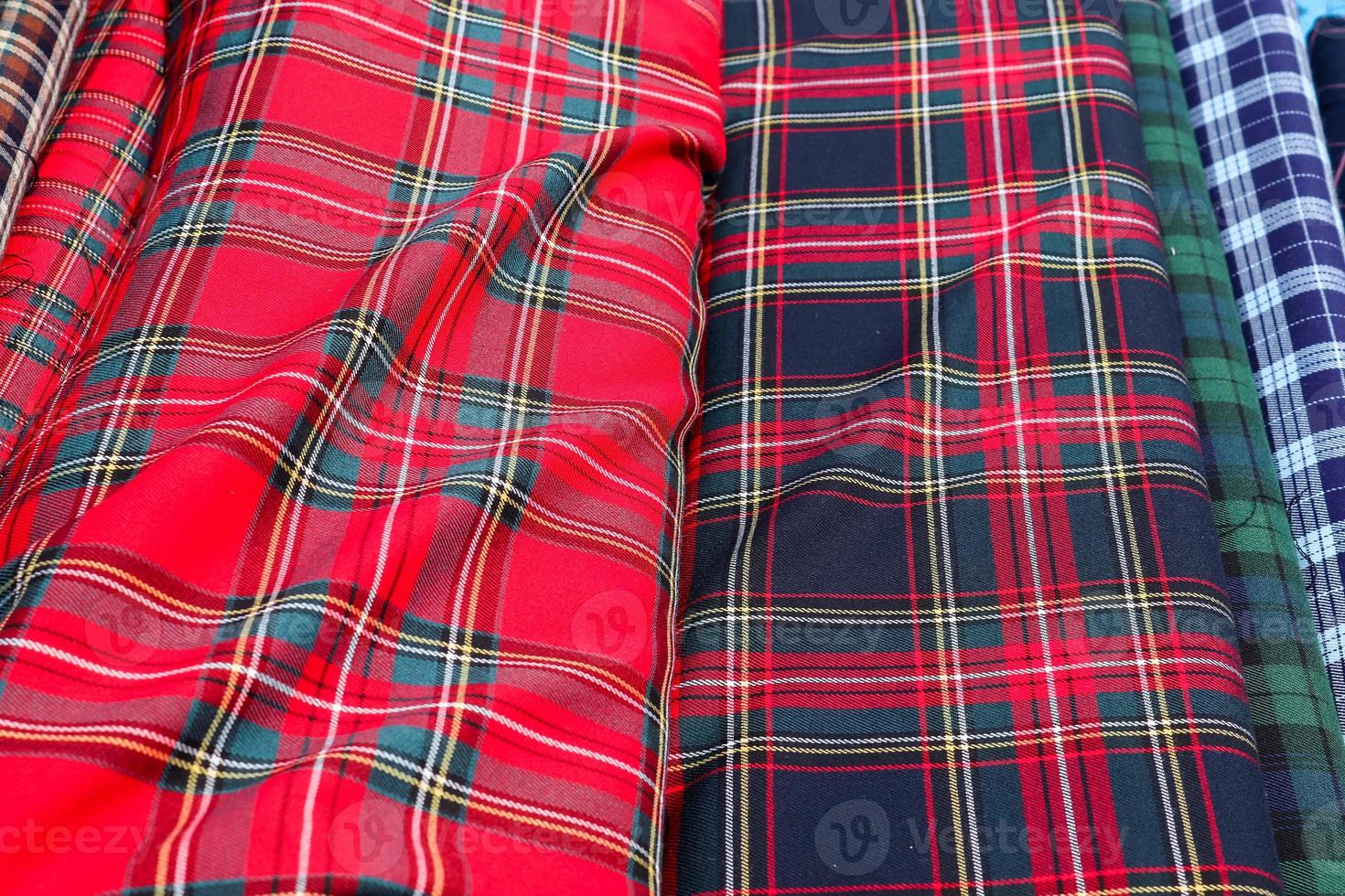 Detailed close up view on samples of cloth and fabrics in different colors found at a fabrics market photo
