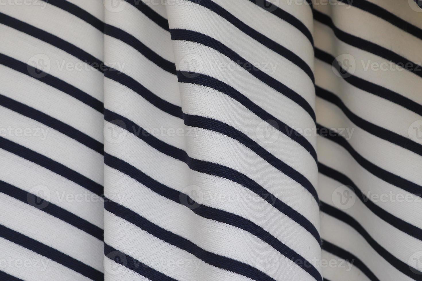 Detailed close up view on samples of cloth and fabrics in different colors found at a fabrics market photo