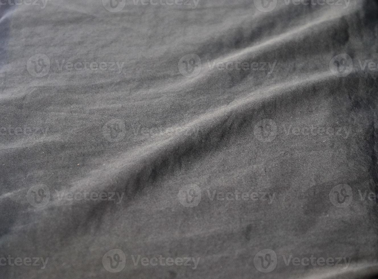 Detailed close up view on samples of cloth and fabrics in different colors found at a fabrics market photo