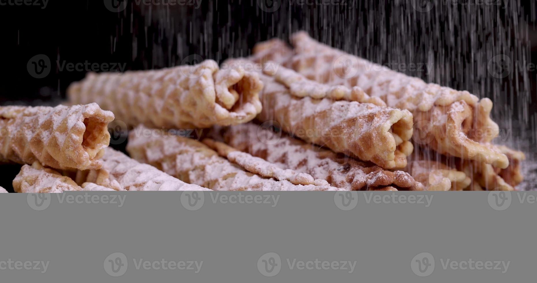 crispy waffles are sprinkled with white powdered sugar photo