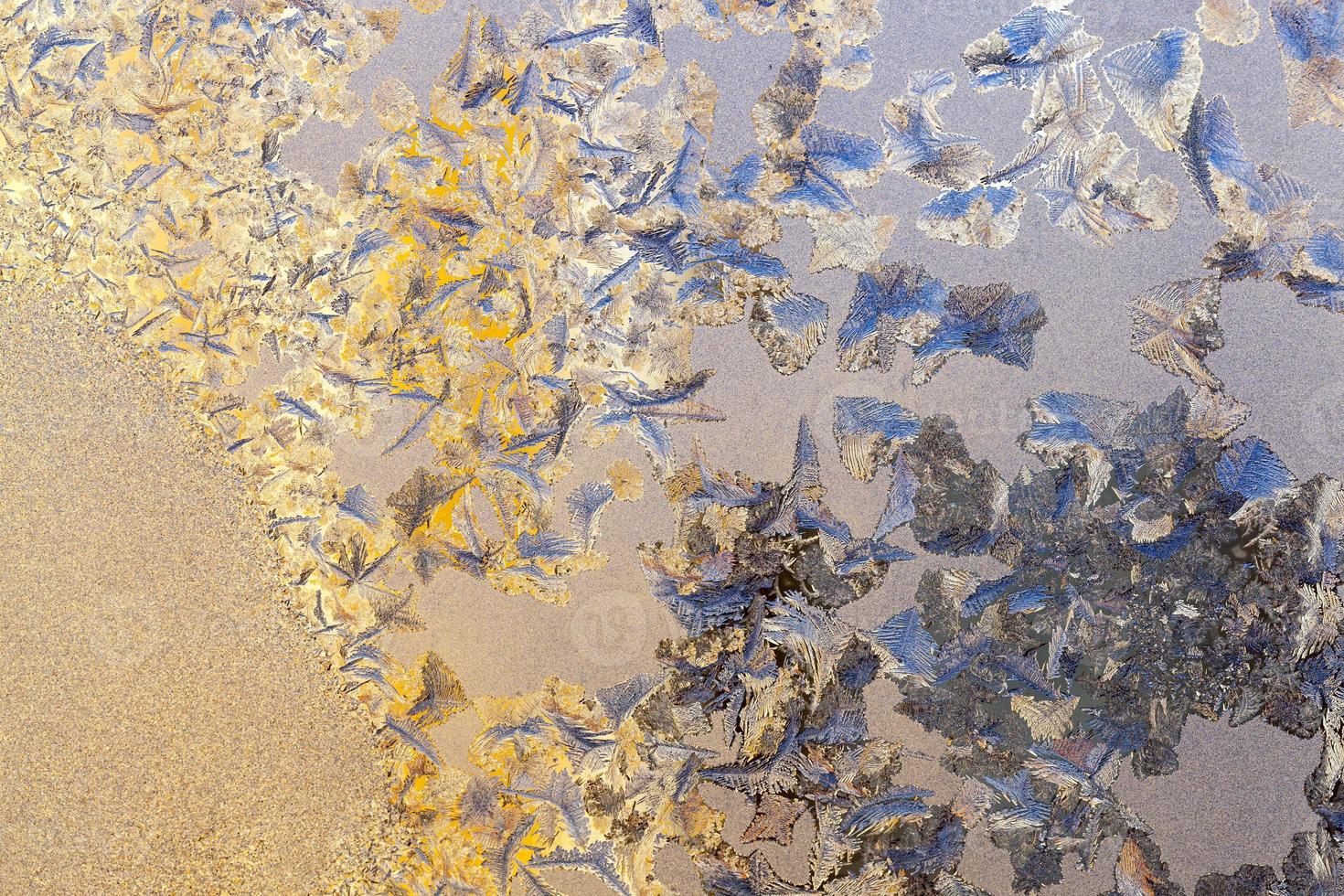 different drawings of frost on the window glass photo