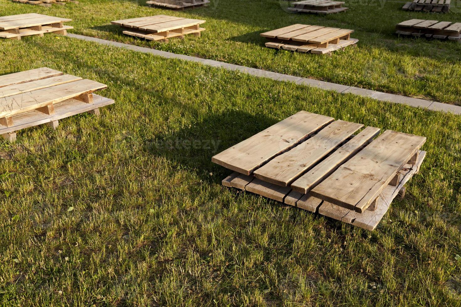 wooden pallets on the grass, close up 9406250 Stock Photo at Vecteezy