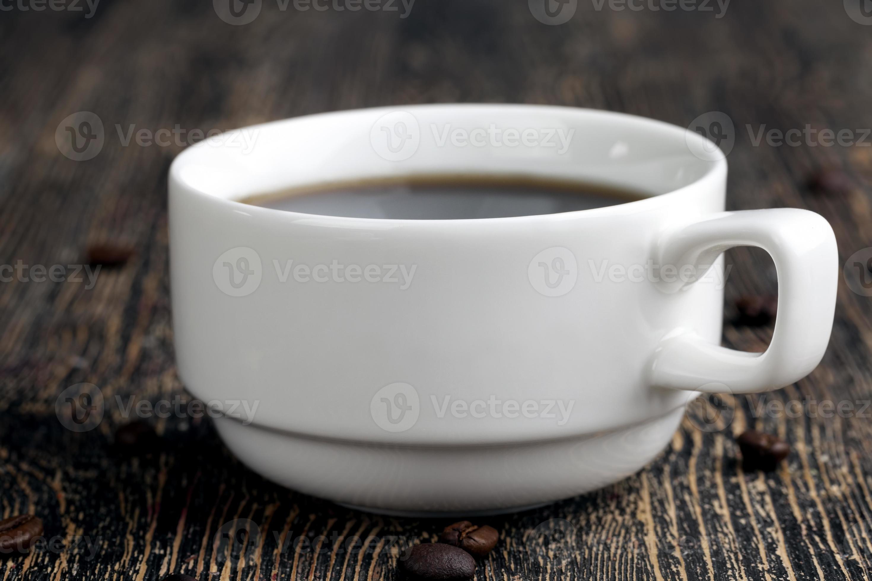 a white mug with a black drink and coffee beans 9406954 Stock Photo at