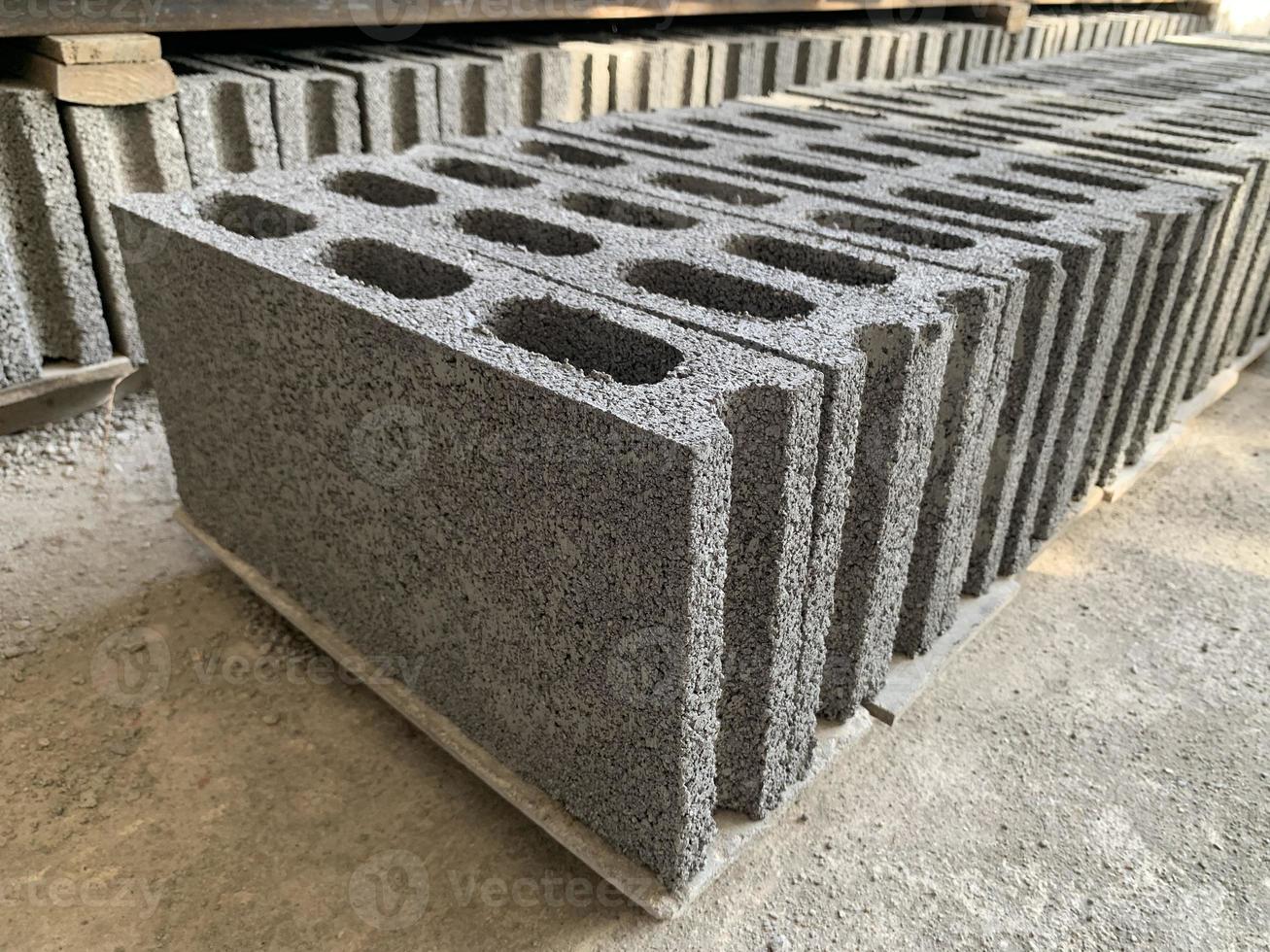 collection of cement block or brick lined up in warehouse photo