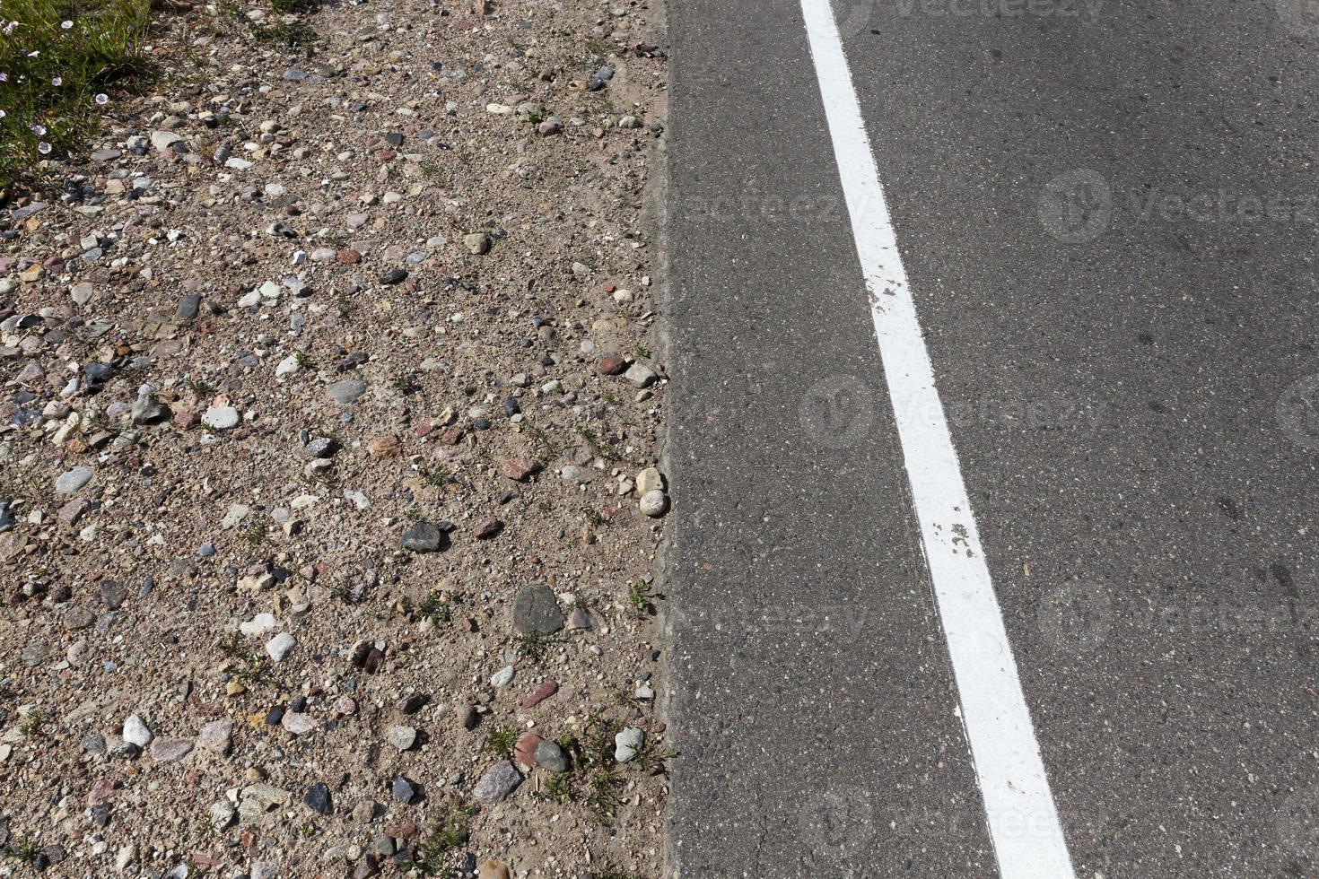 asphalt road with white road markings photo