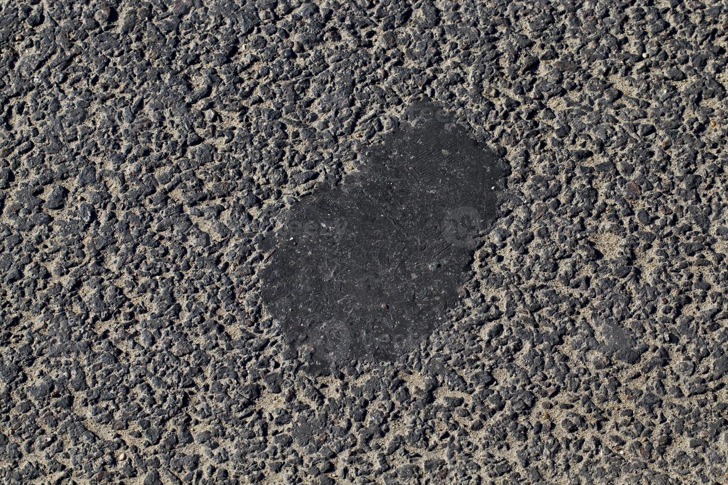 repaired part of the asphalt road photo