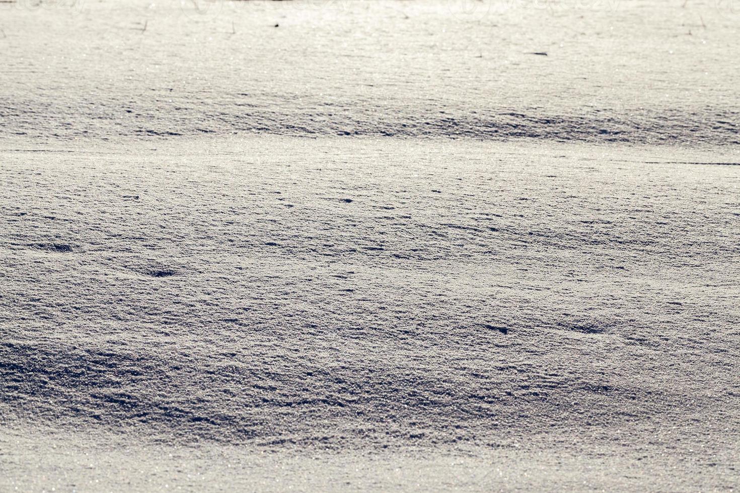 Snow after snowfall   snow lying in snowdrifts after the last snowfall. Photo in the winter in the field.