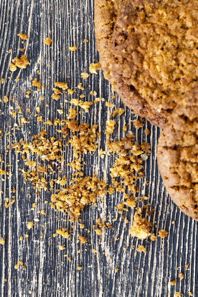 broken cookies with crumbs on the table. photo