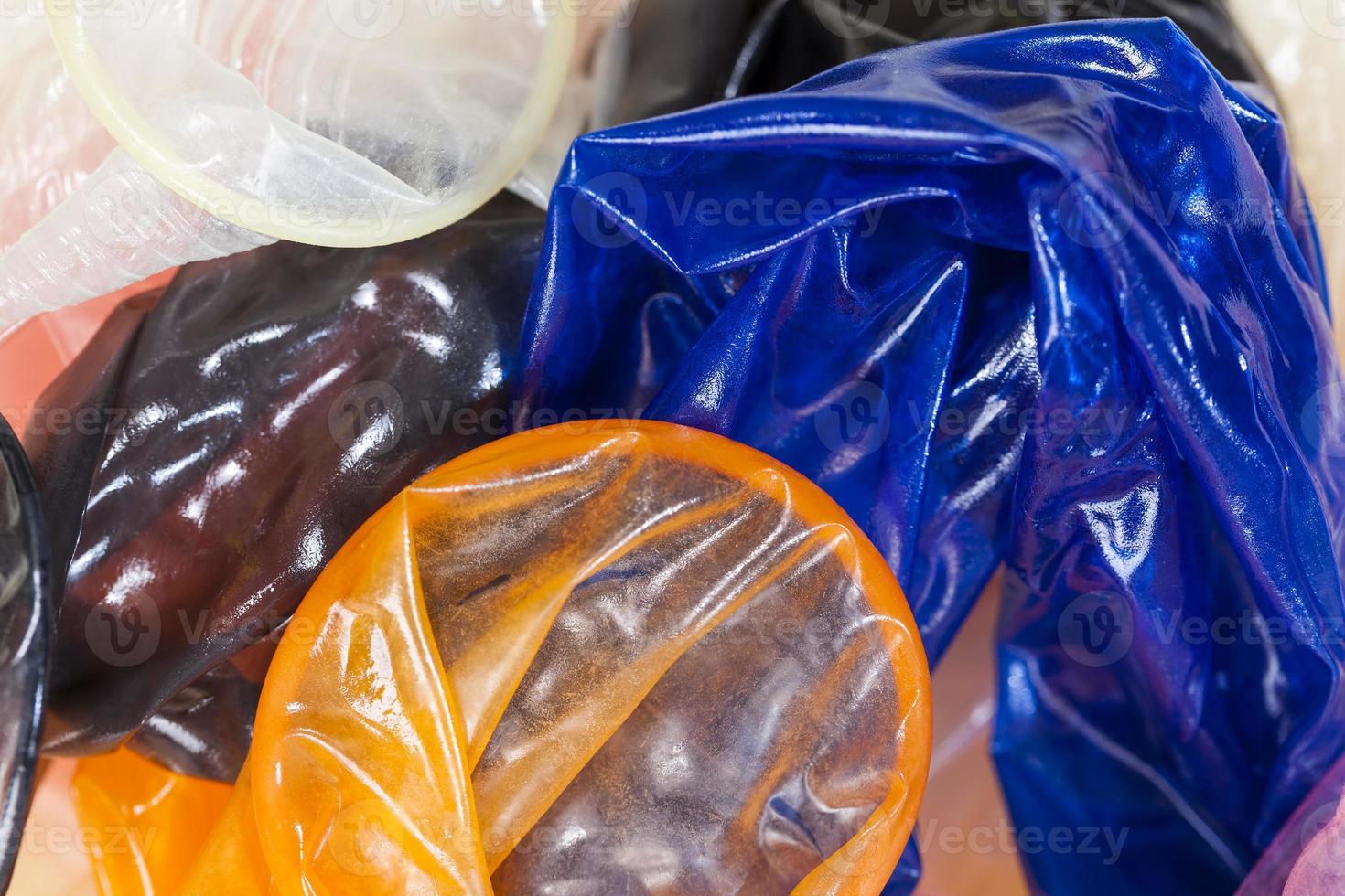 high quality latex condoms in blue, orange, pink photo