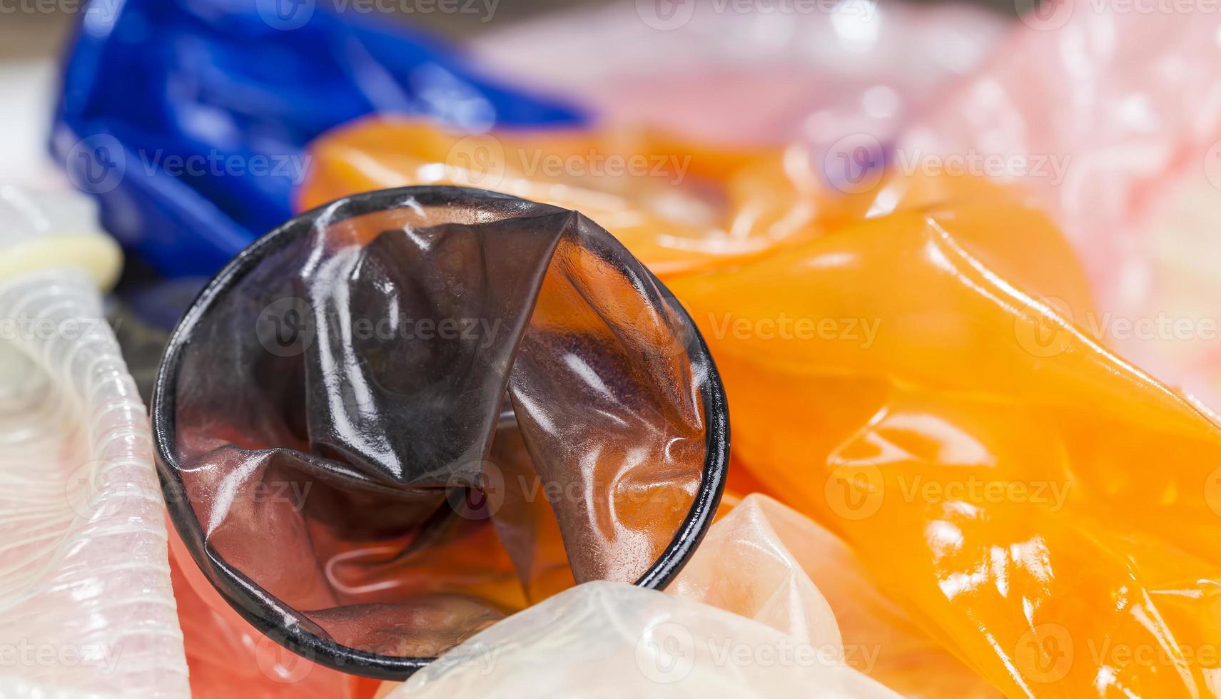 high quality latex condoms in blue, orange, pink photo