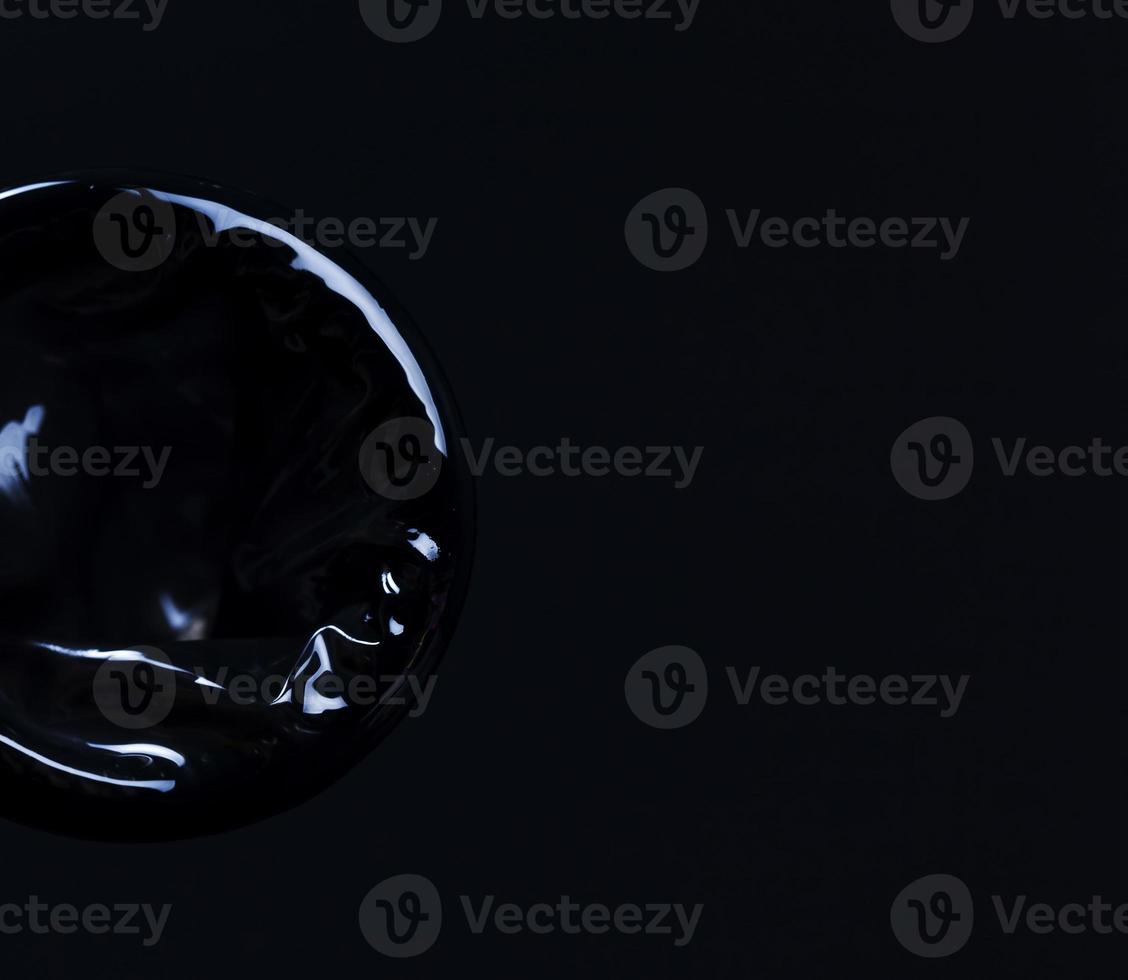 new black condom on a black background photo