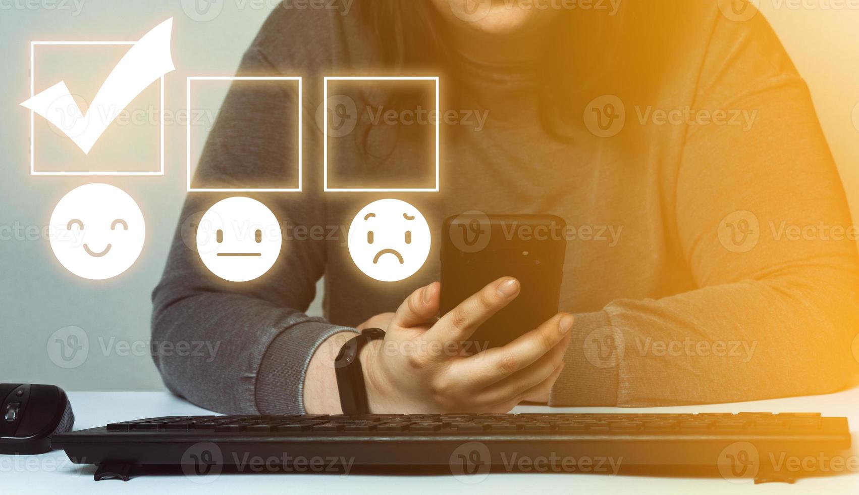 Customer service and satisfaction concept. Woman rating service on her phone with a happy smile face hologram. photo