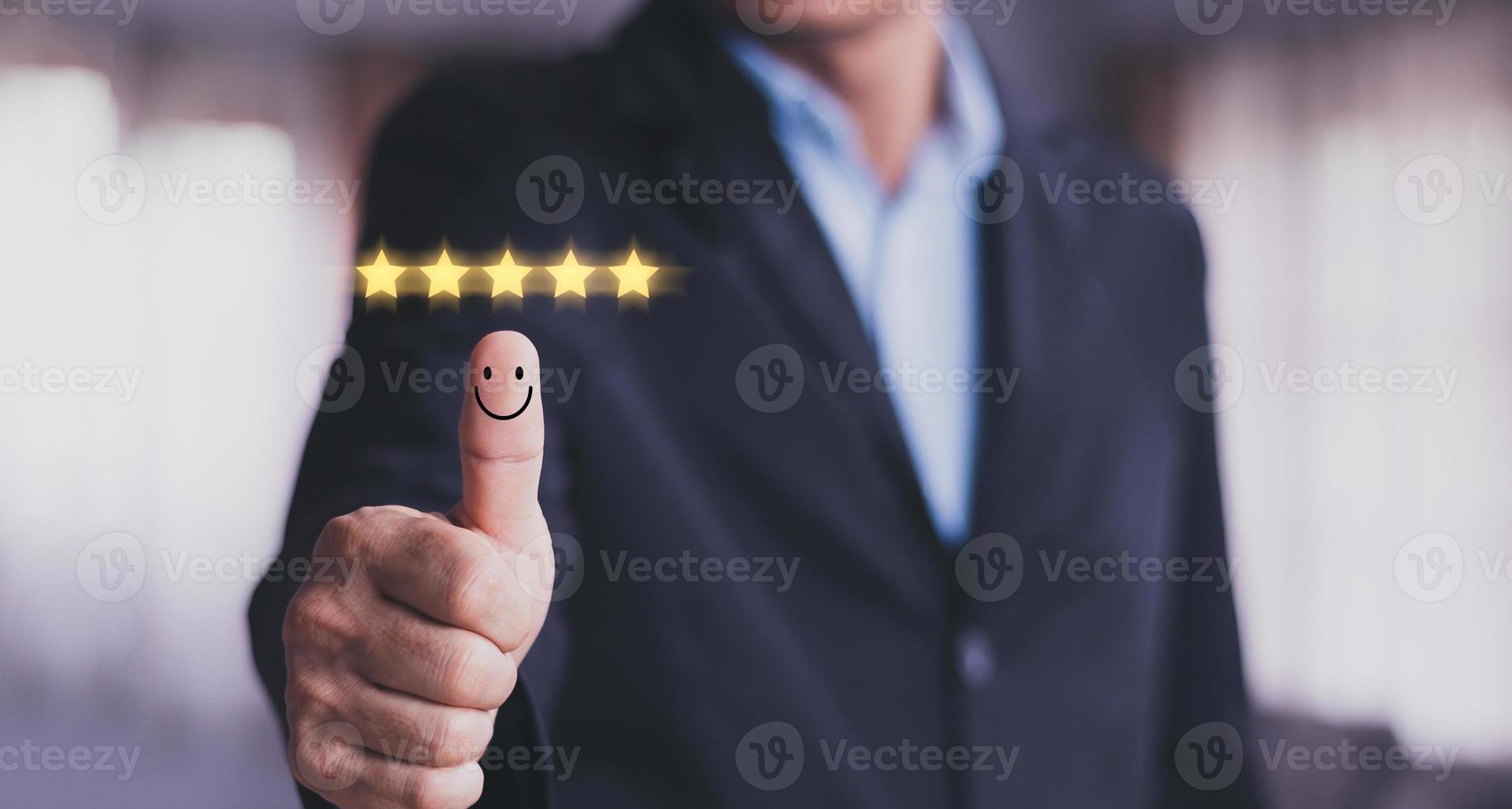 Customer satisfaction concept. Hand with thumb up Positive emotion smiley face icon and five star with copy space. photo