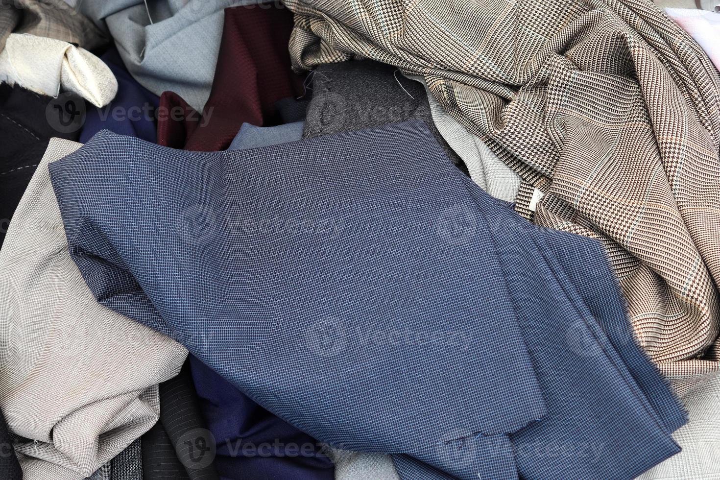 Detailed close up view on samples of cloth and fabrics in different colors found at a fabrics market photo