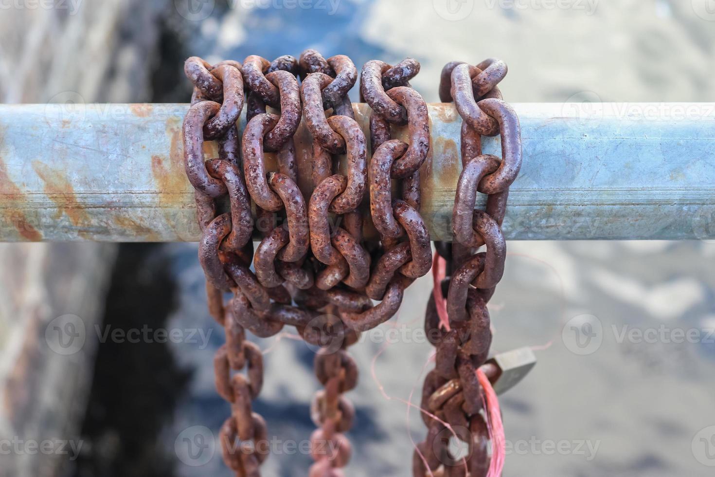 Rusty chain around metal bars at the port of Kiel. photo