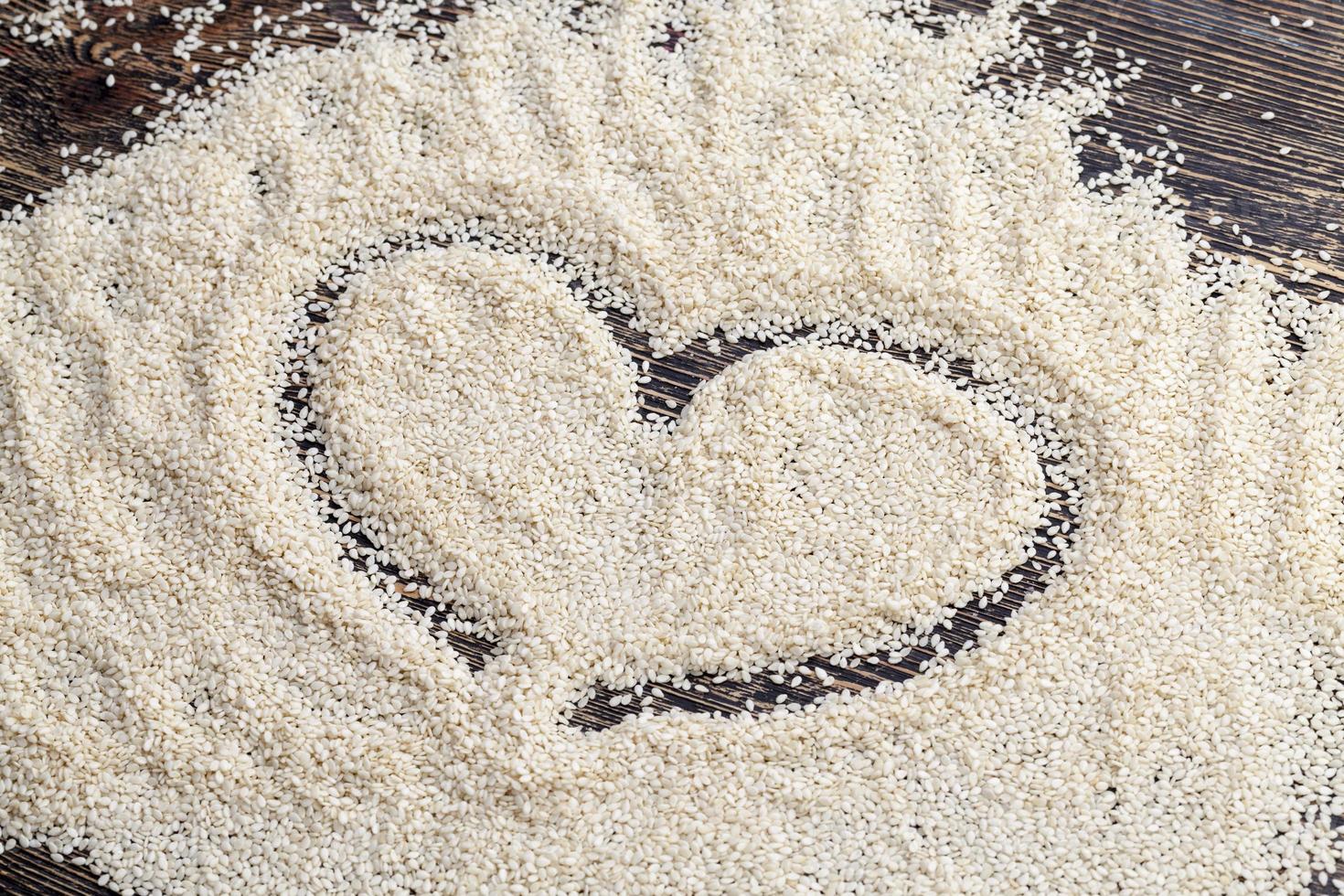 white sesame seeds on a wooden table photo