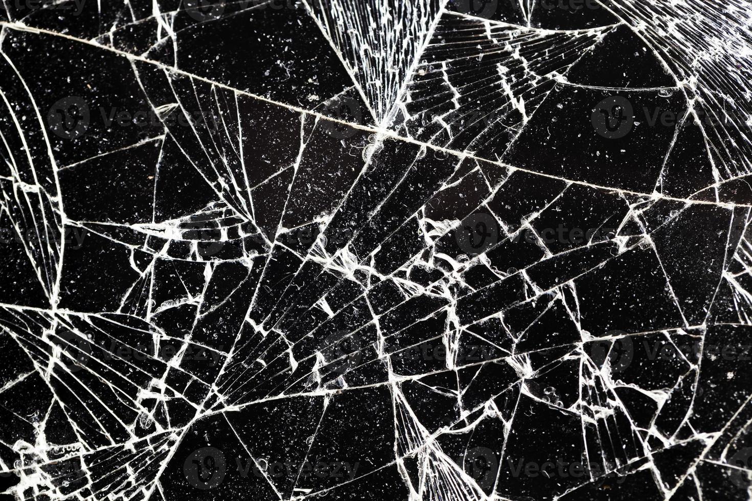 broken thin glass with lots of cracks photo