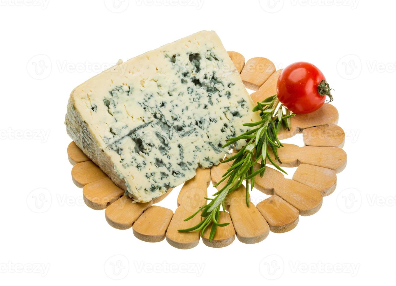 Blue cheese on wooden plate and white background photo