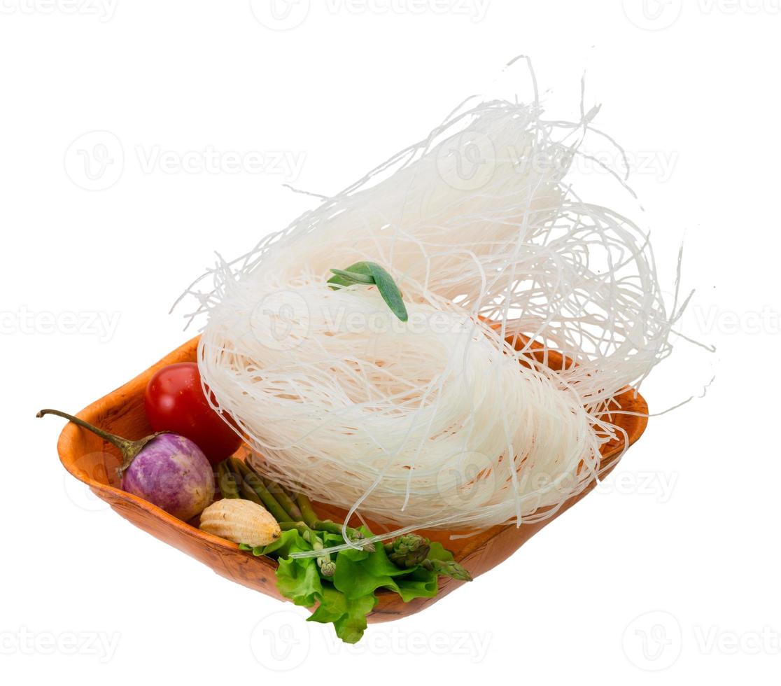 Raw rice noodles in a bowl on white background photo