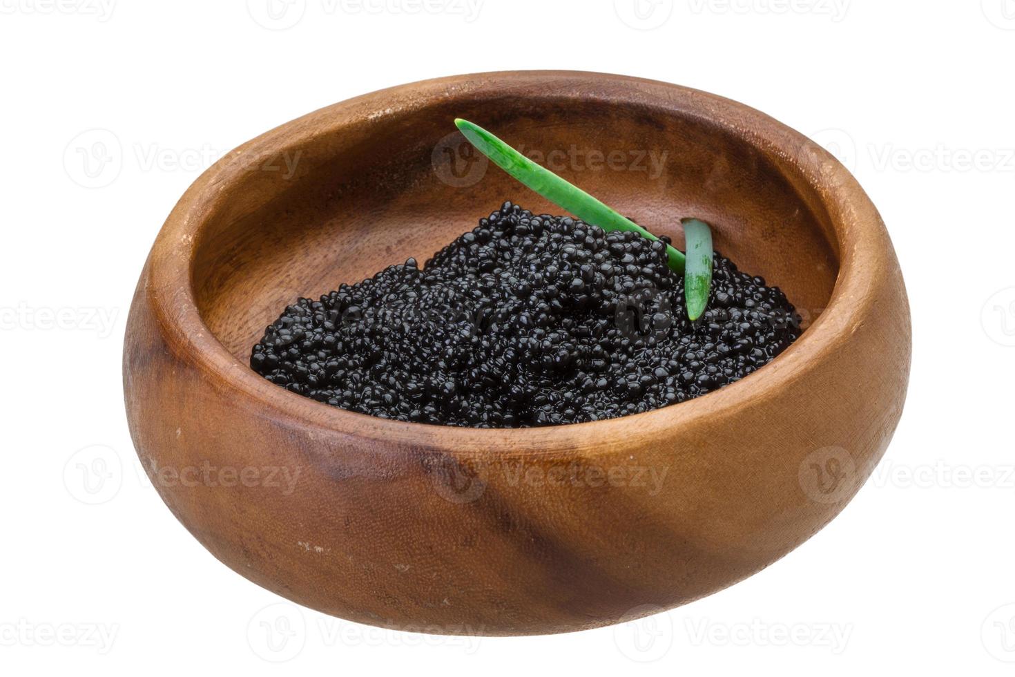 Black caviar in a bowl on white background photo