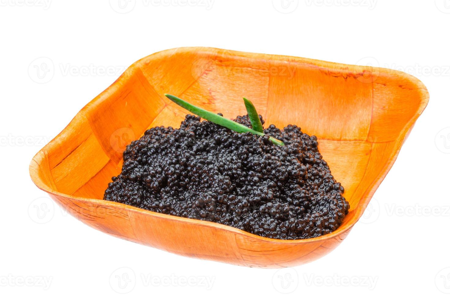 Black caviar in a bowl on white background photo