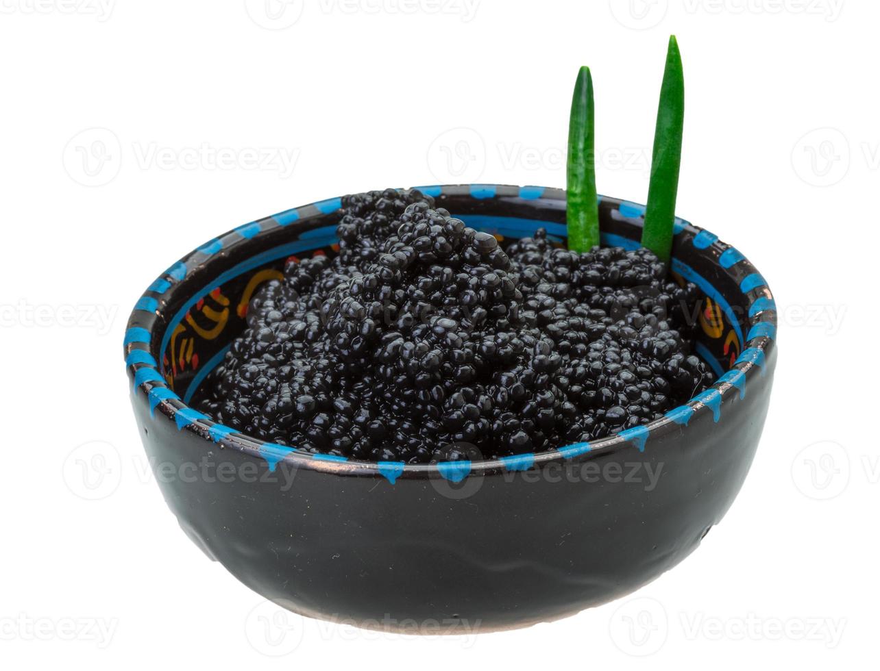 Black caviar in a bowl on white background photo