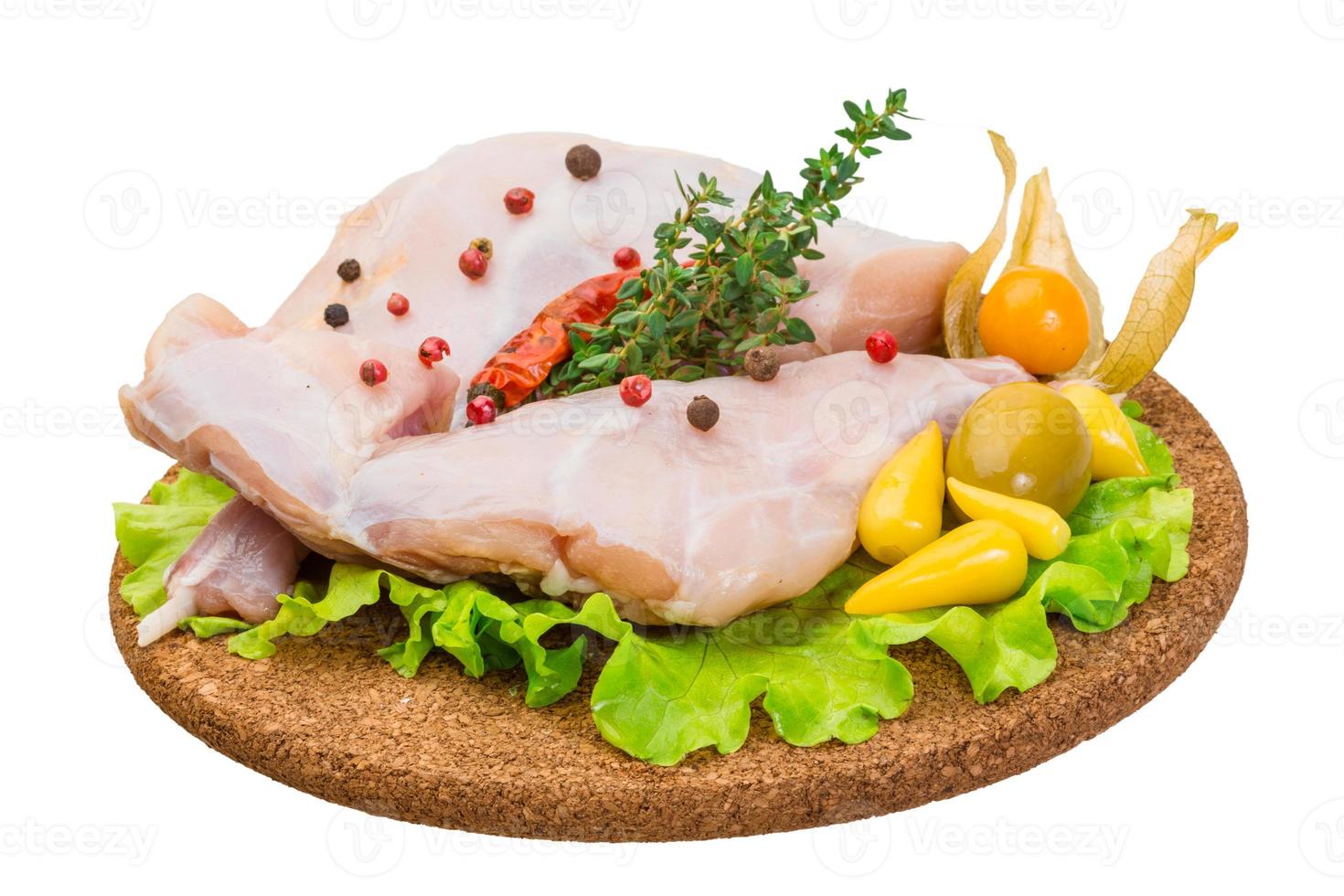 Raw rabbit meat on wooden plate and white background photo