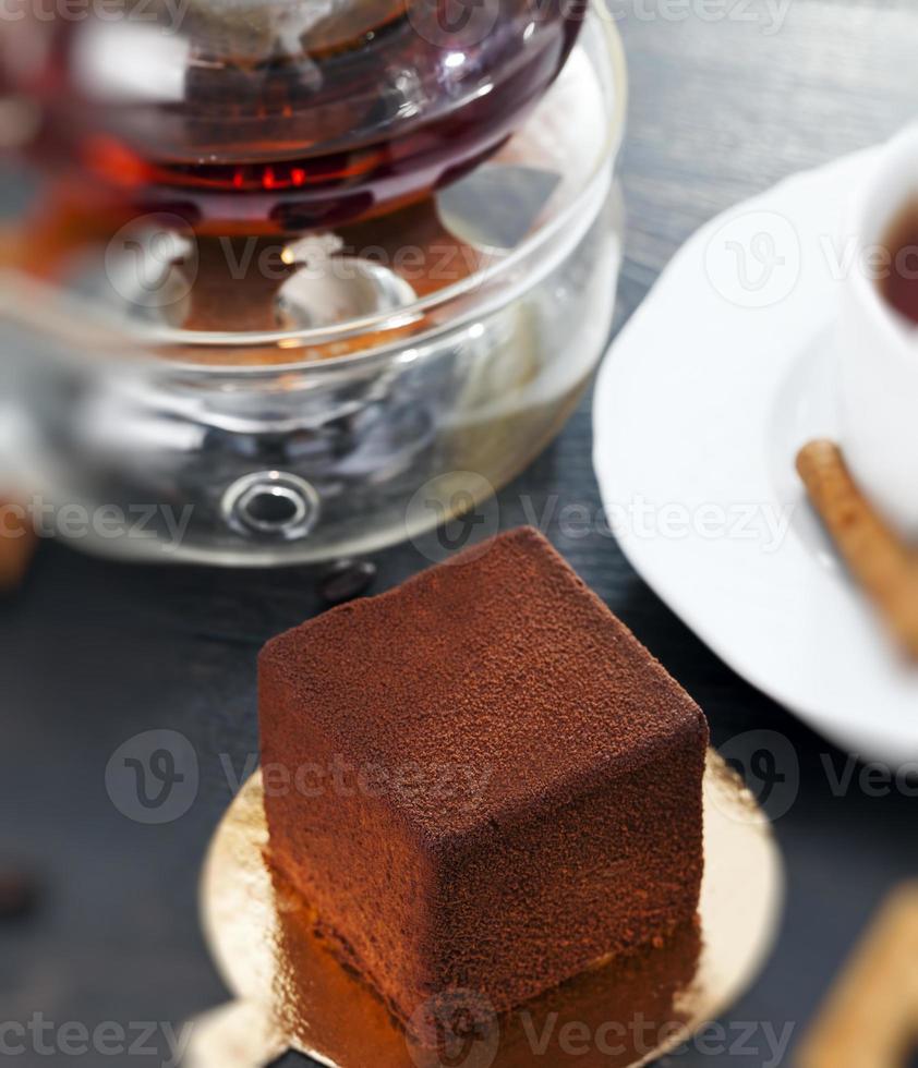 delicious chocolate cake with a cube shape on the table photo