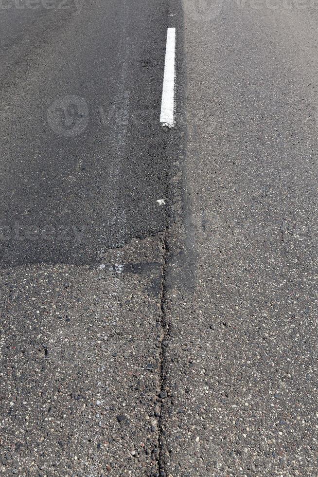 paved road with white road markings photo