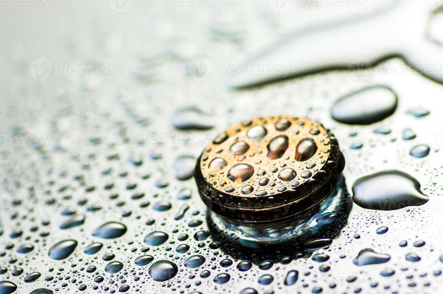 Abstract golden shiny object with droplets. Round wet object close up view. photo