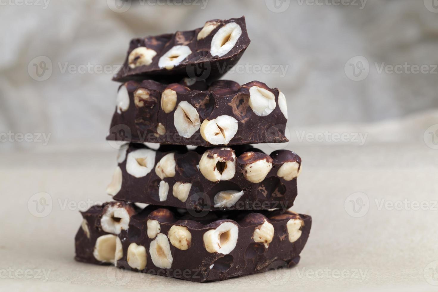 milk chocolate with whole and chunks of hazelnuts photo