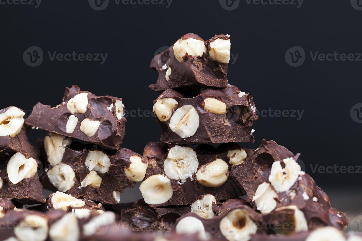milk chocolate with whole and chunks of hazelnuts photo