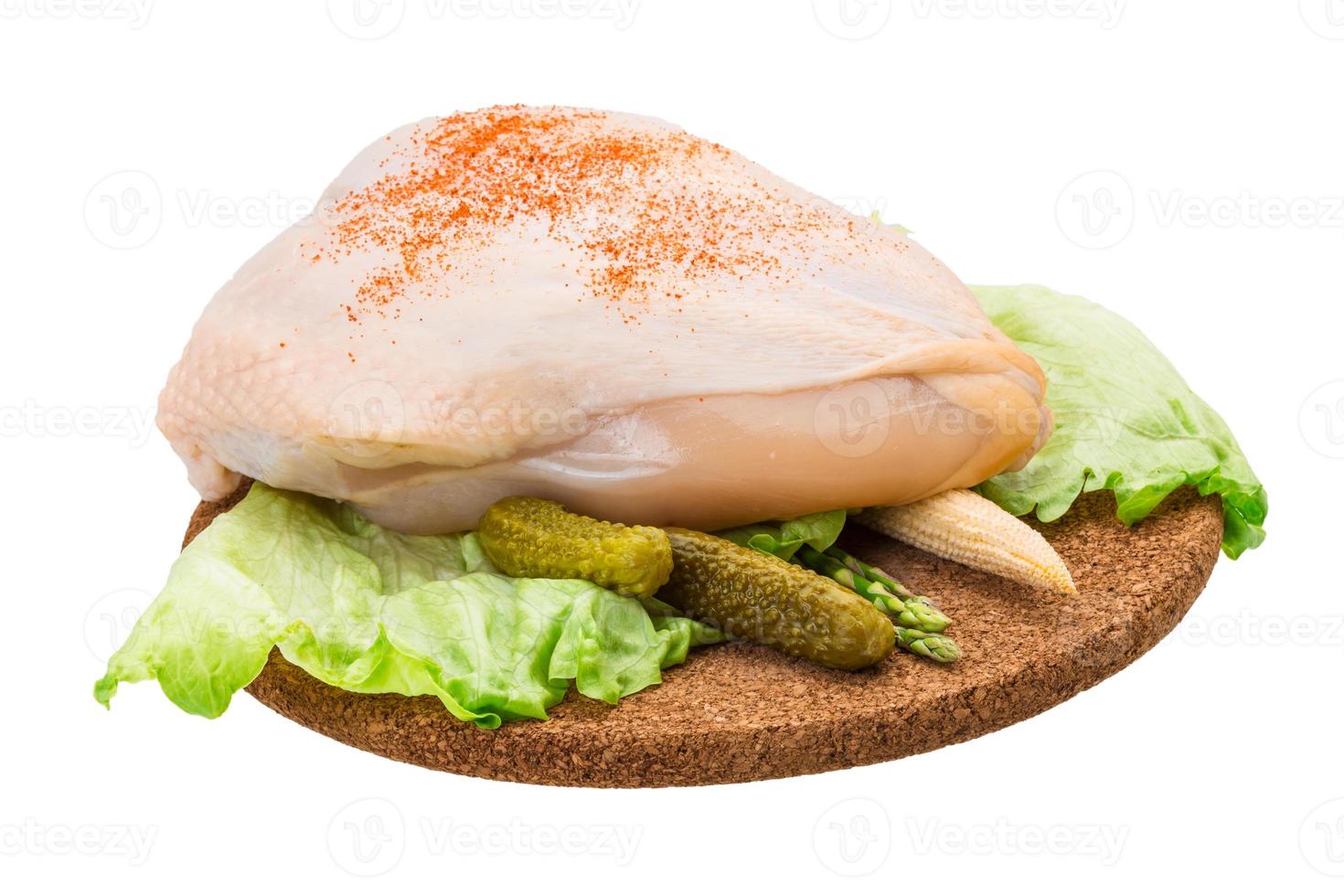 Chicken breast on wooden plate and white background photo