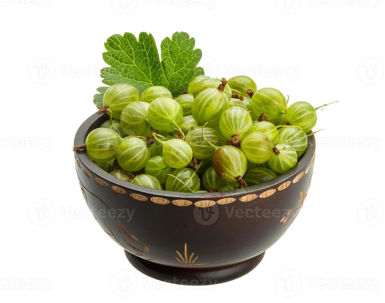 Gooseberries in a bowl on white background photo