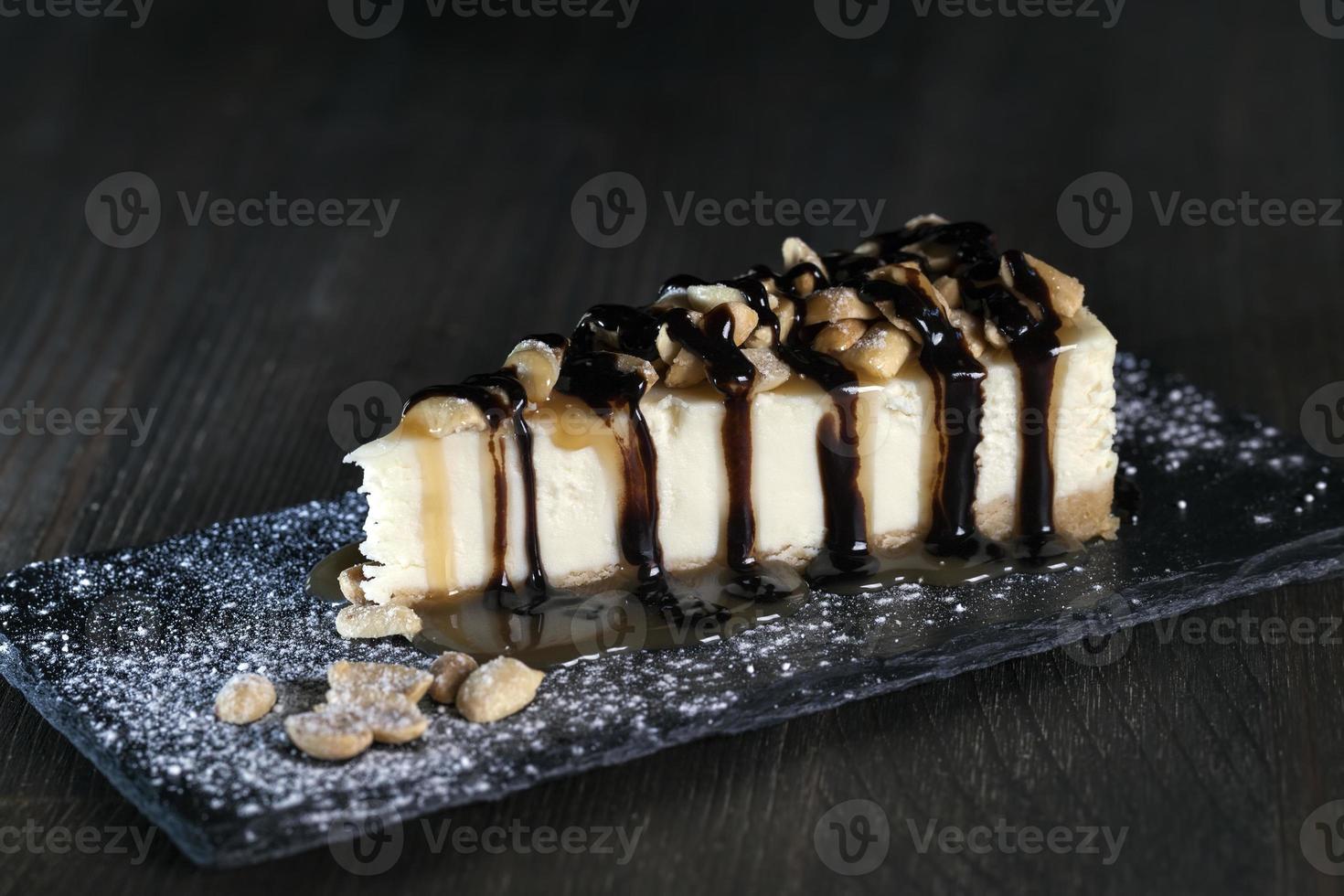 dessert cheesecake covered with caramel and chocolate photo