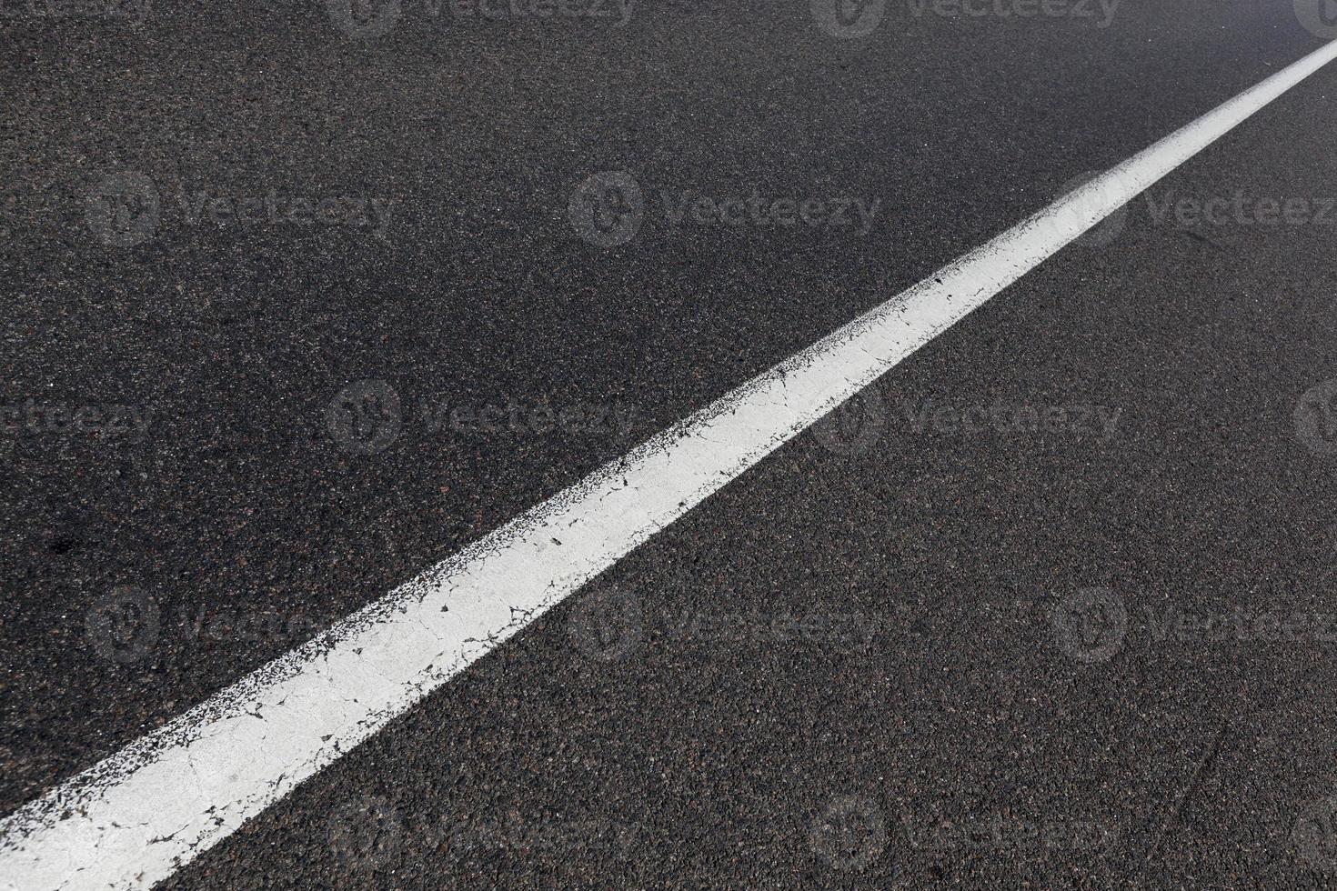 paved road with white road markings photo