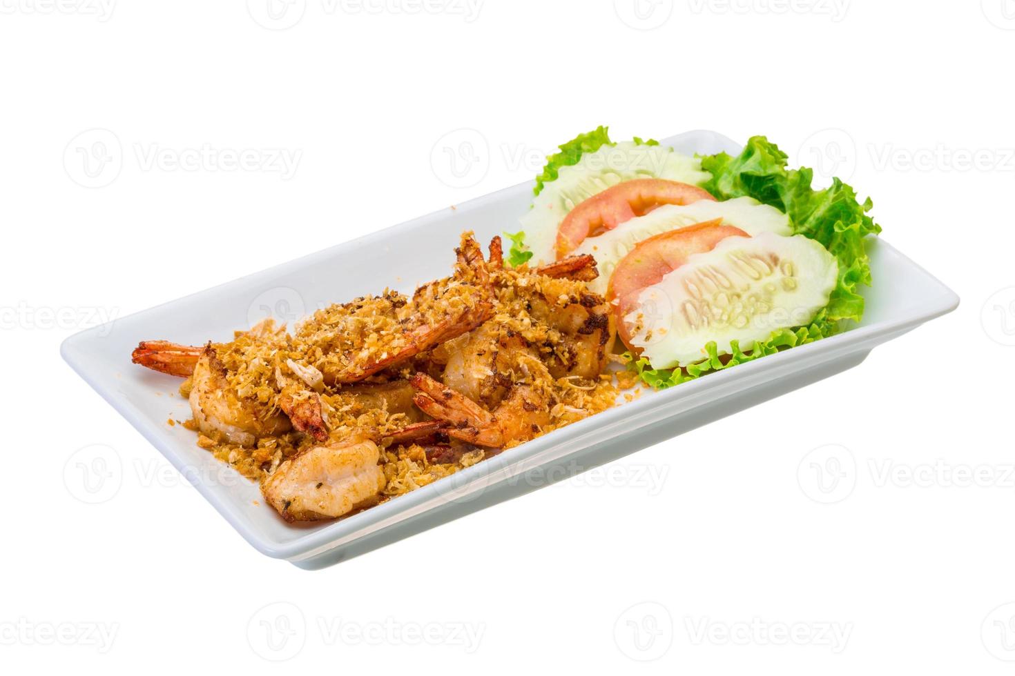 Fried shrimps with garlic on the plate and white background photo