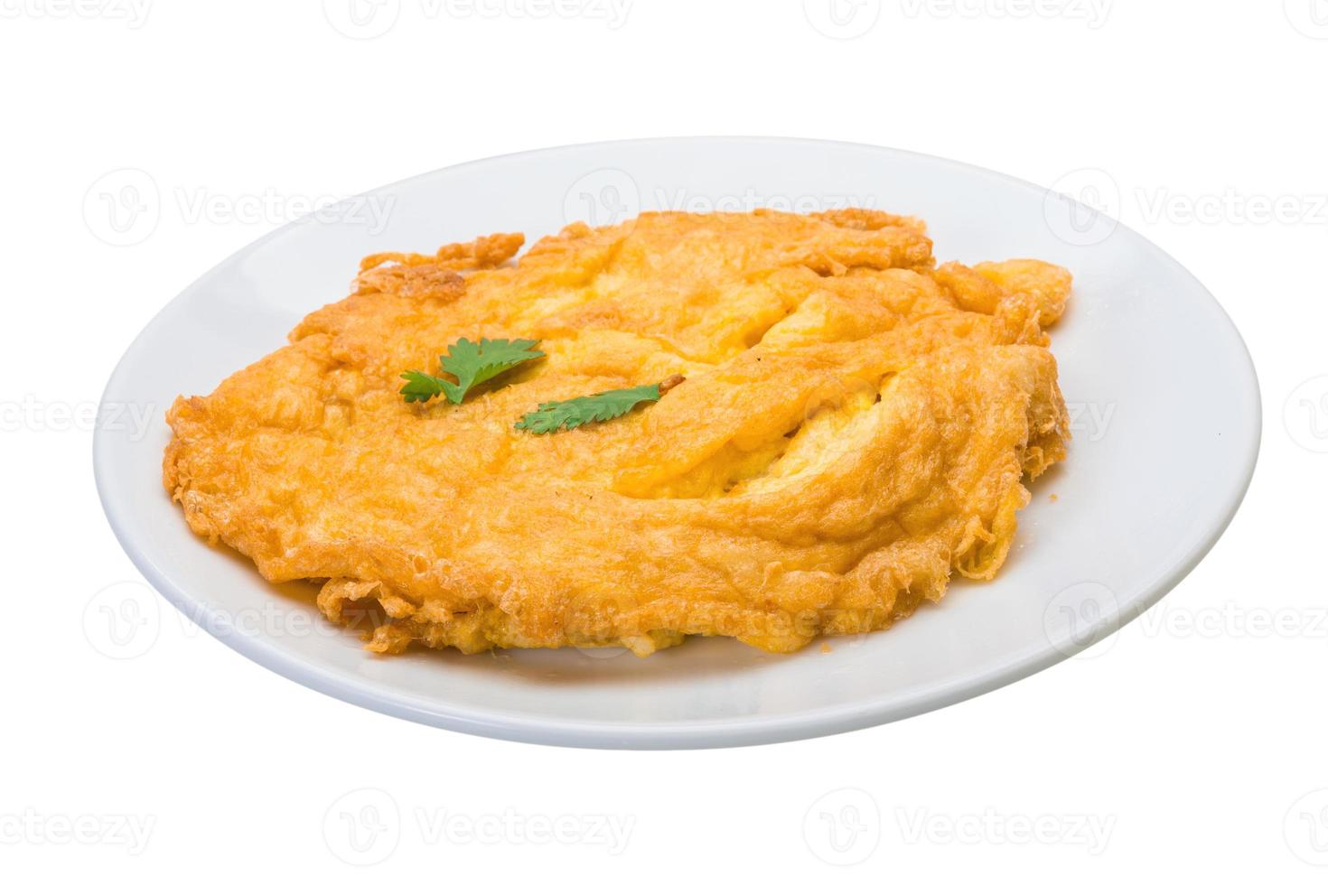 Omelette with crab meat on the plate and white background photo