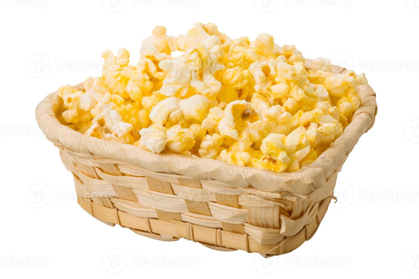 Popcorn in a basket on white background photo