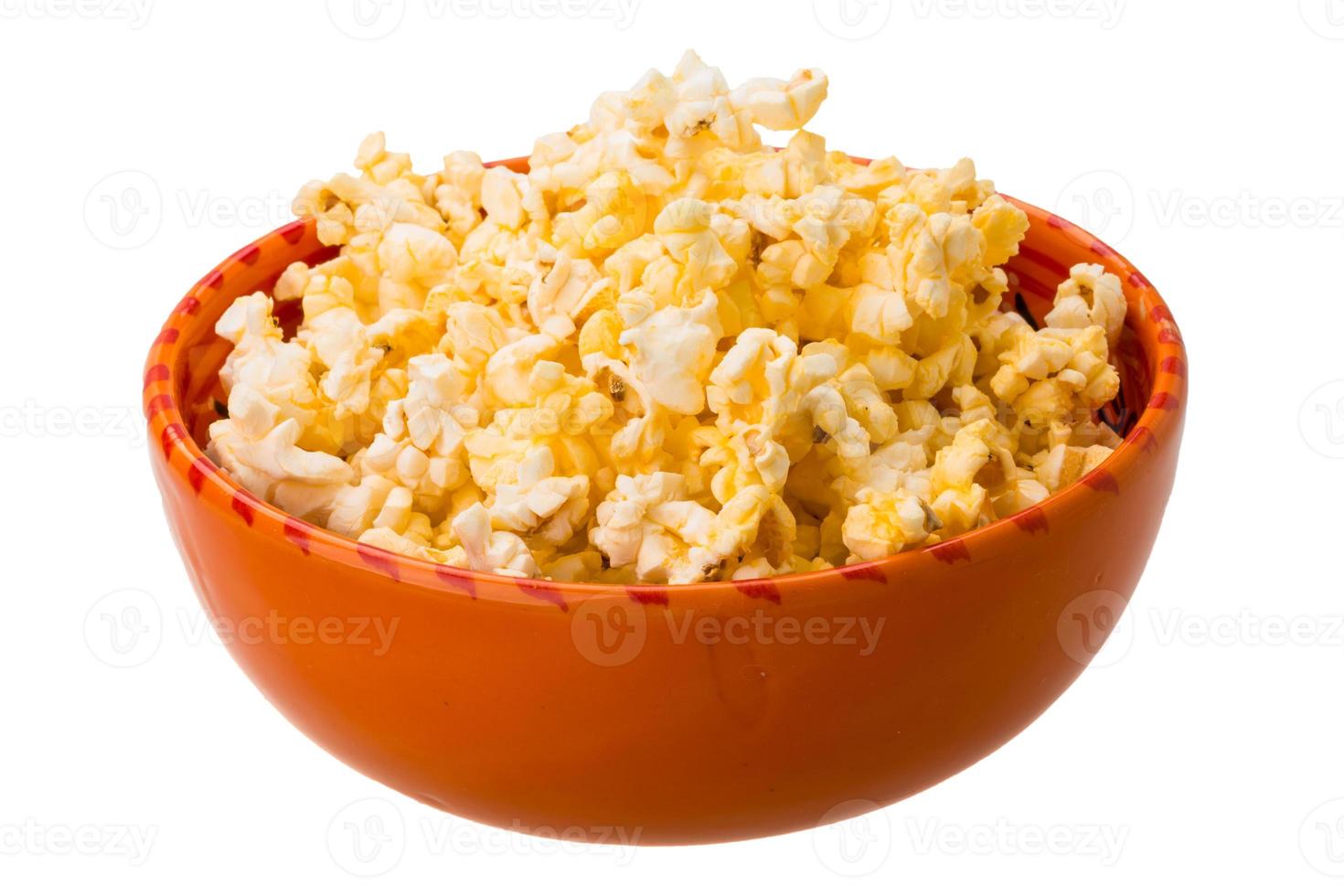 Popcorn in a bowl on white background photo