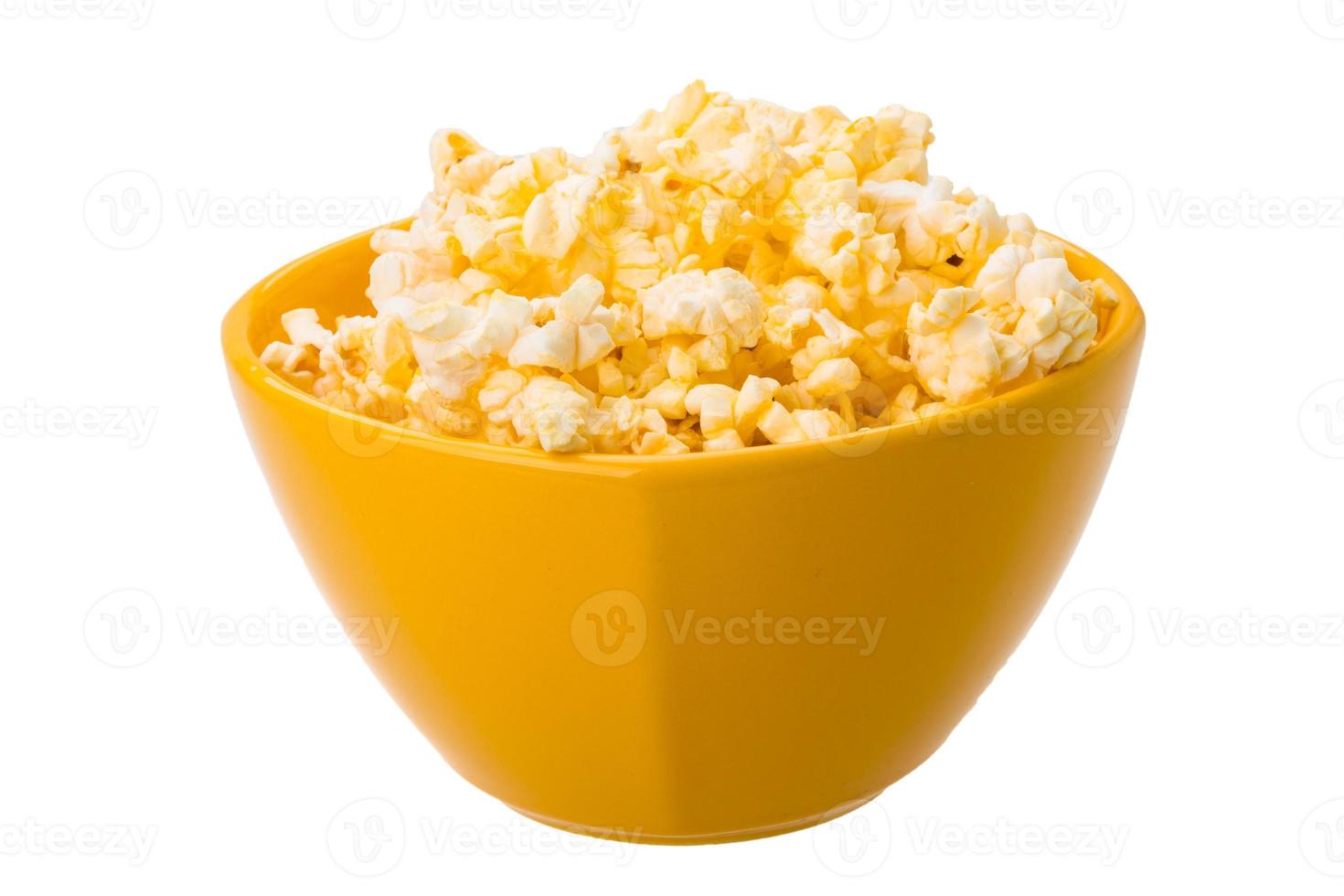 Popcorn in a bowl on white background photo