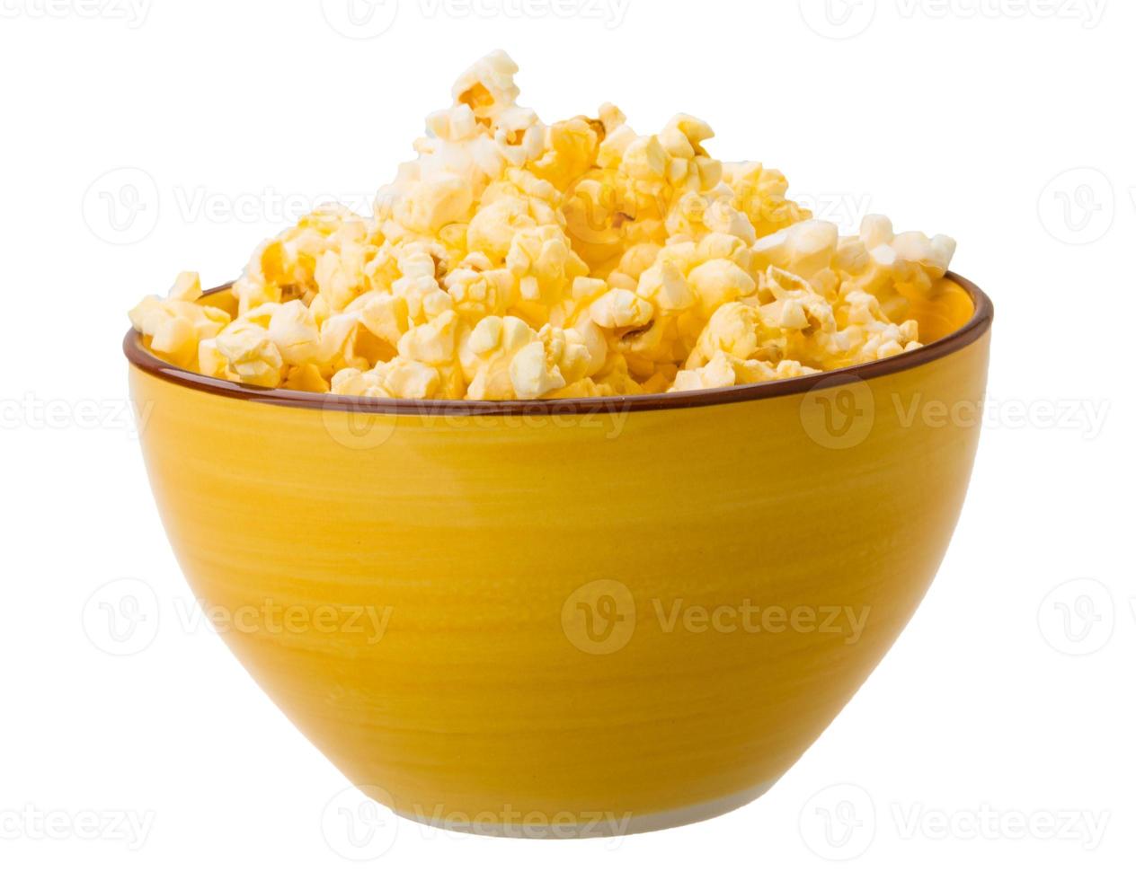 Popcorn in a bowl on white background photo