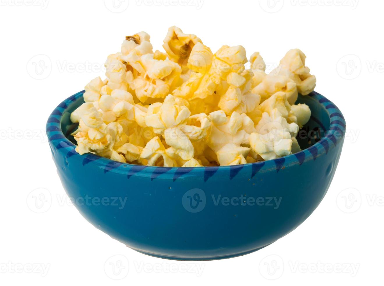 Popcorn in a bowl on white background photo