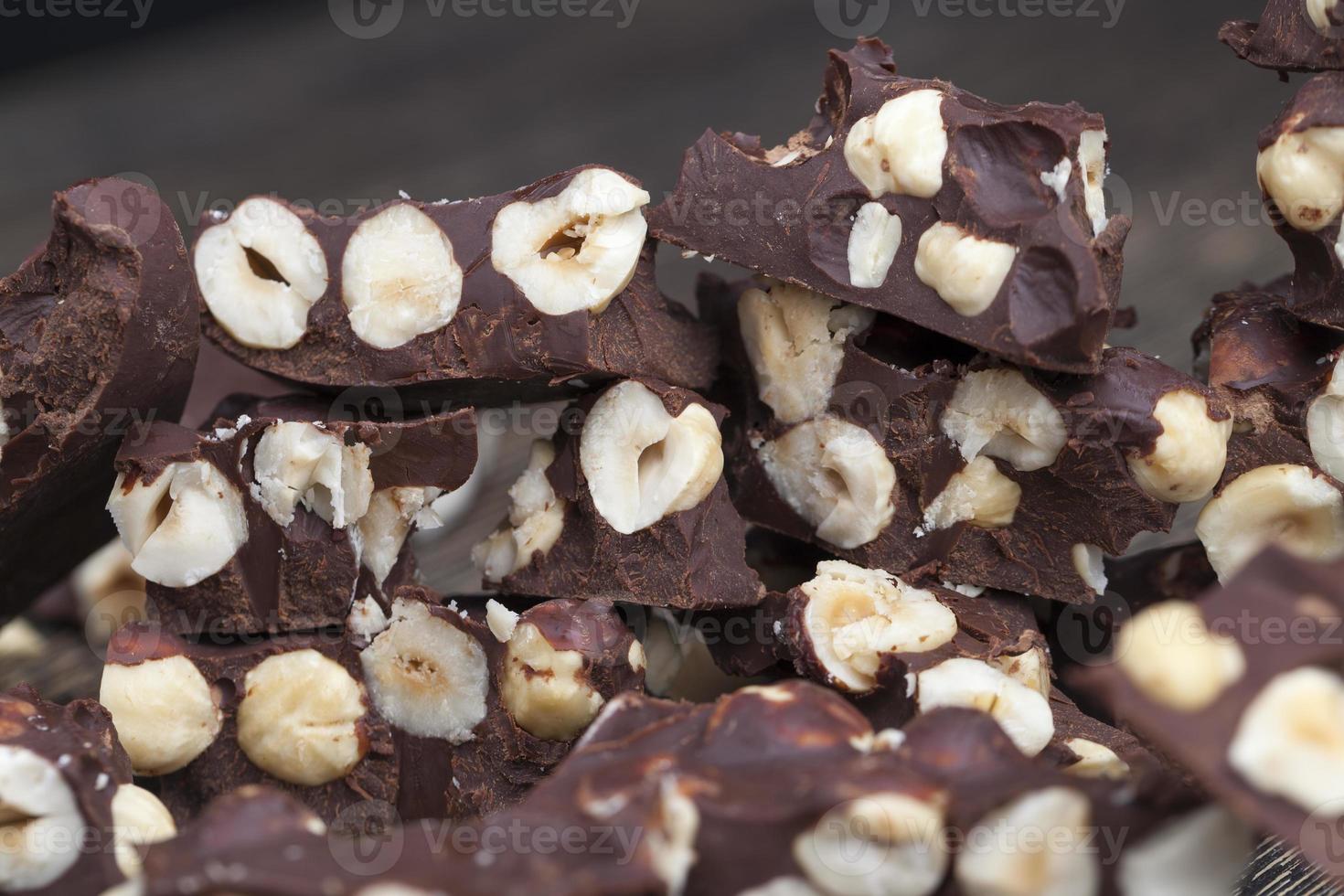 milk chocolate with whole and chunks of hazelnuts photo
