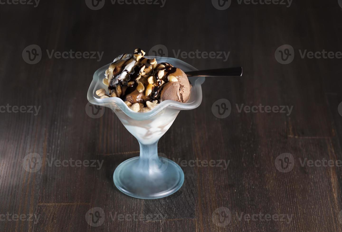 chocolate ice cream with peanuts, caramel and chocolate photo