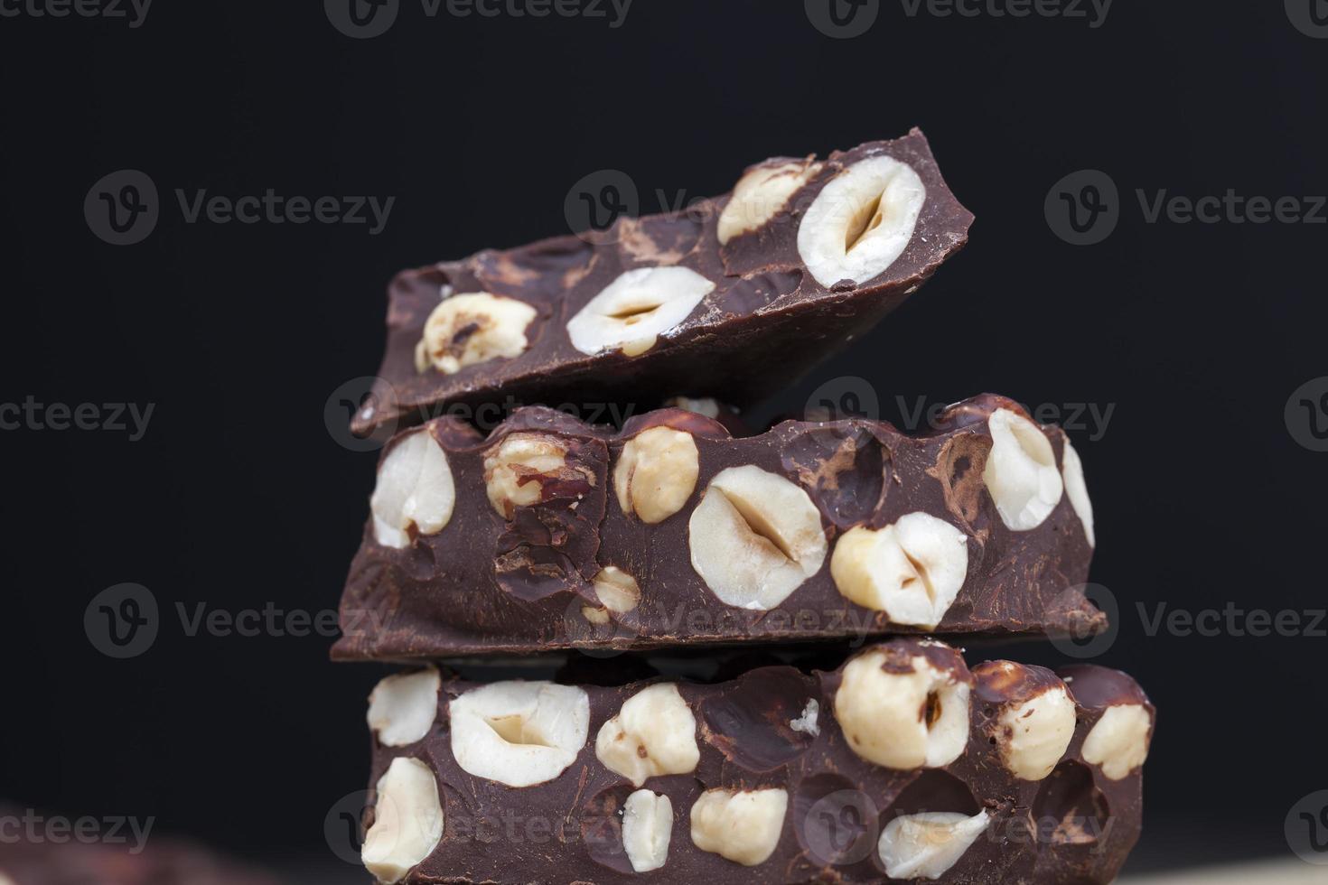 milk chocolate with whole and chunks of hazelnuts photo