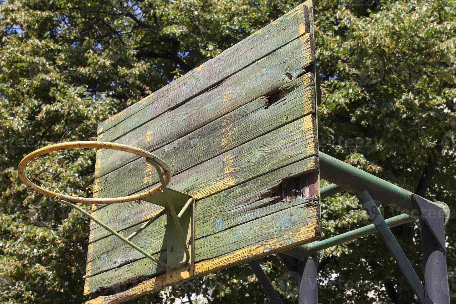 an old basketball ring in the yard photo