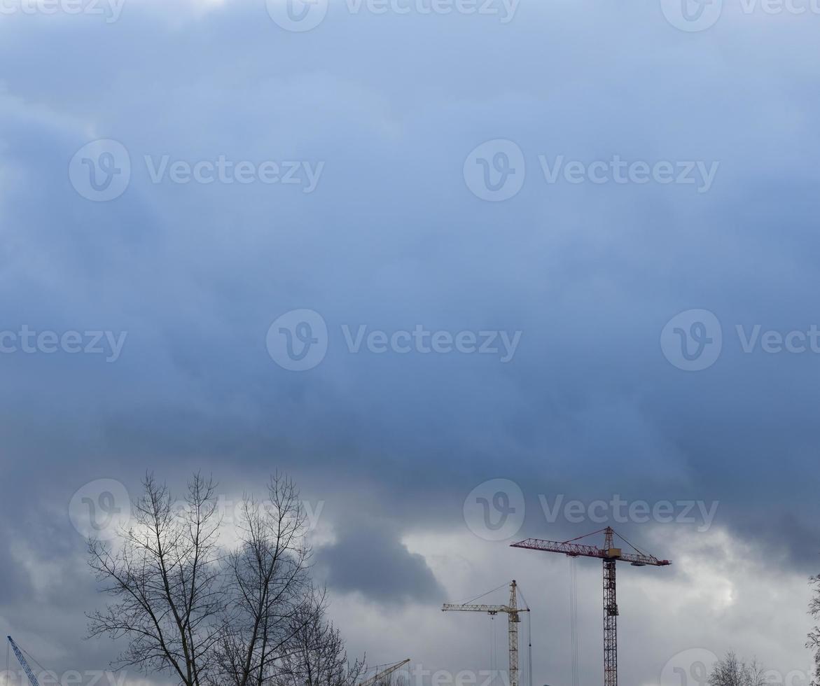 Construction cranes and sky photo