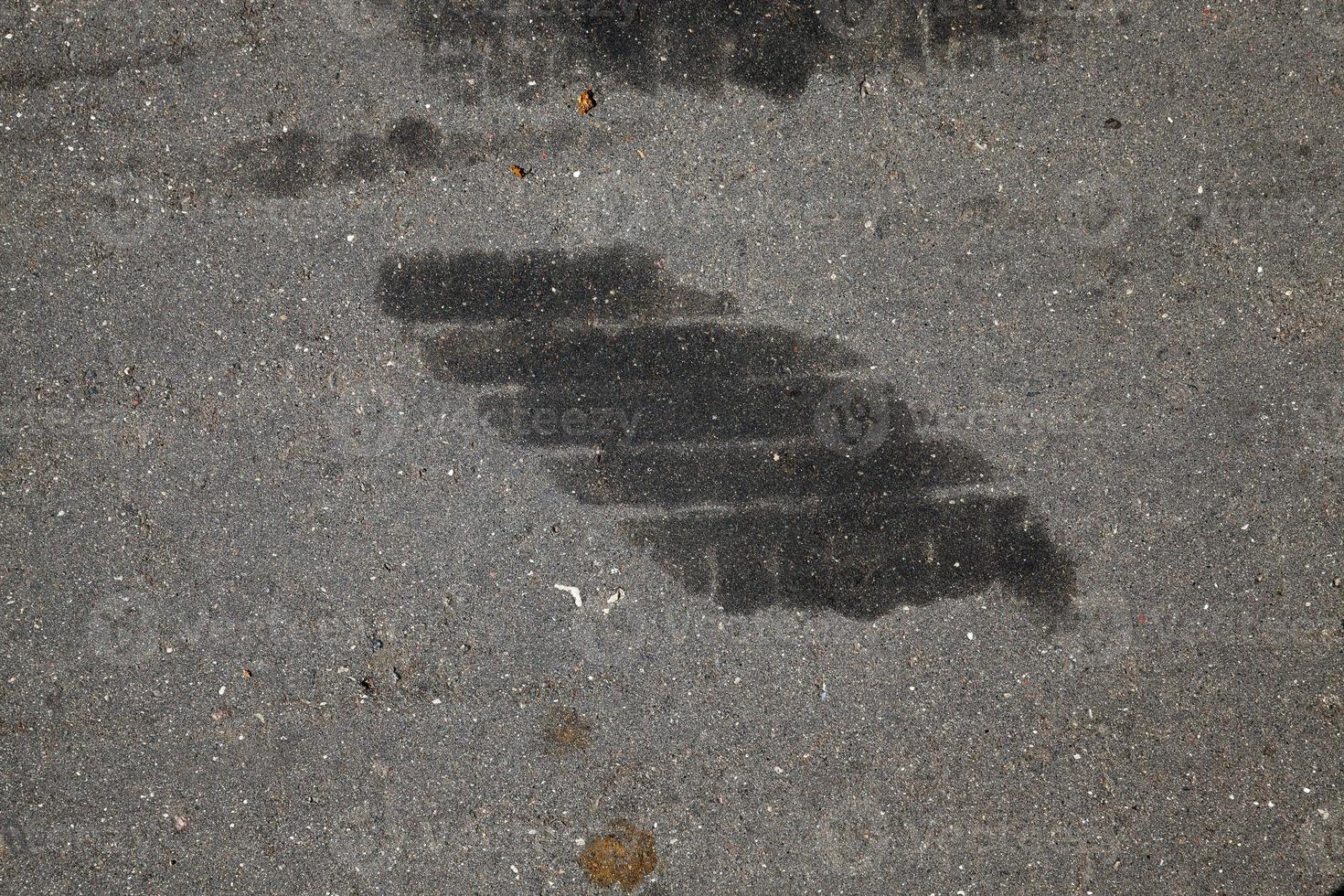 car oil stains on an asphalt road photo