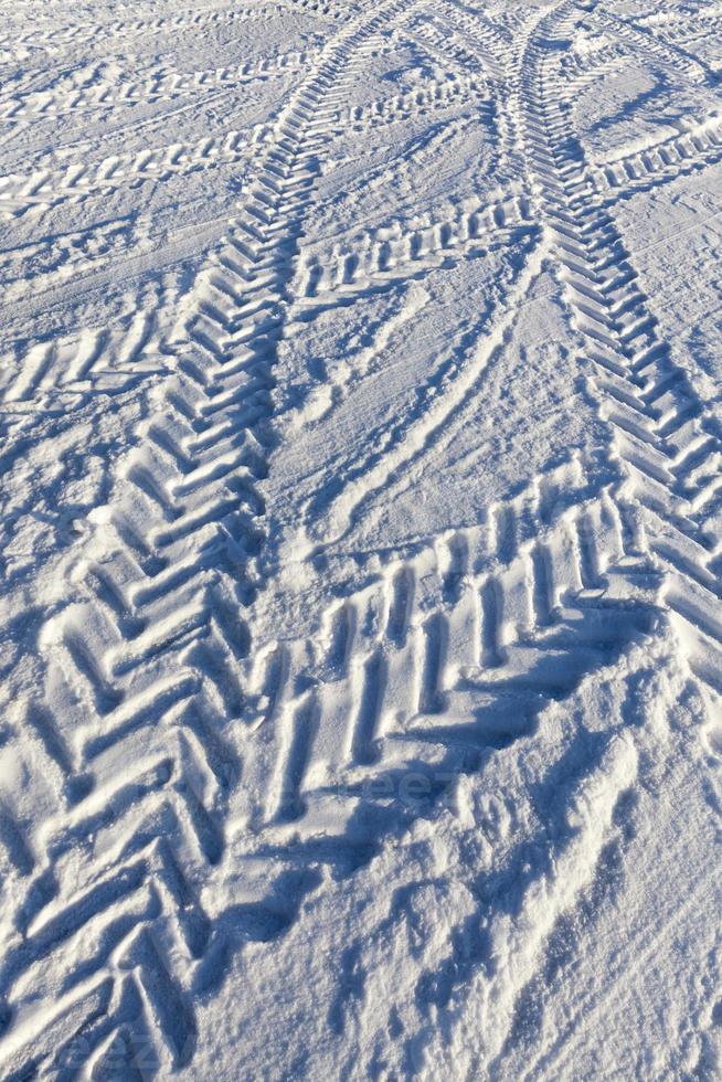 a road covered with snow in the winter season photo